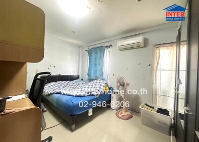 Spacious bedroom with natural lighting and air conditioning