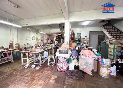 Spacious interior of a large building cluttered with various items and materials