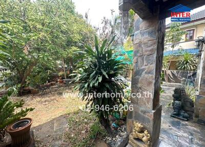 Lush garden with stone path and mature trees in a residential property