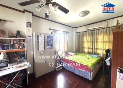 Spacious bedroom with natural lighting and study area