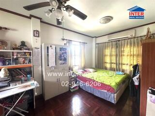 Spacious bedroom with natural lighting and study area