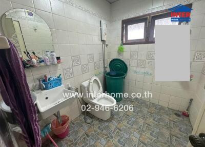 Spacious bathroom with window and tiled floor