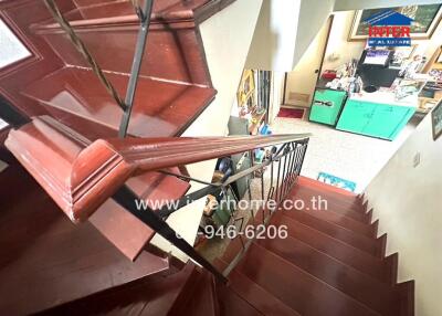 Interior staircase with view into kitchen area