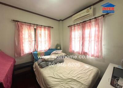 Cozy bedroom with natural light and air conditioning