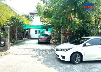 front view of a residential house with a driveway and cars