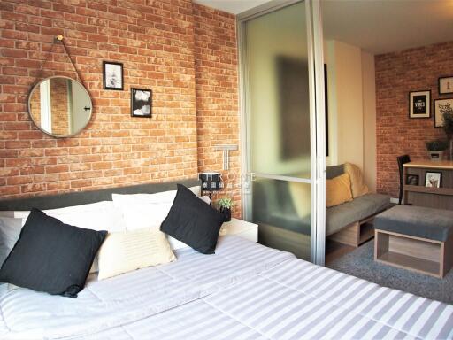 Cozy bedroom with exposed brick wall and modern decor