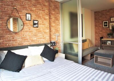 Cozy bedroom with exposed brick wall and modern decor