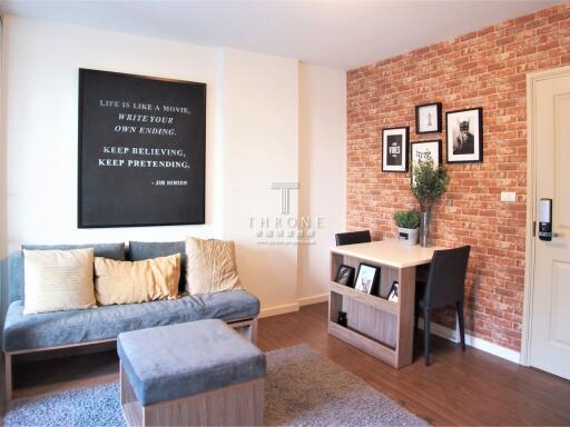Modern and cozy living room with brick wall feature and inspirational wall art