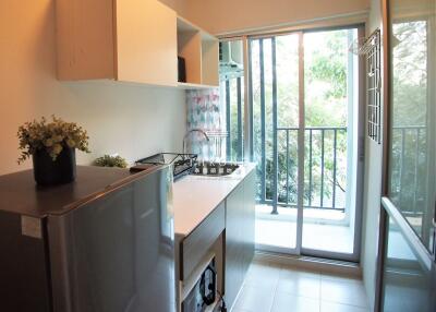 Modern kitchen with stainless steel appliances and natural light