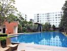 Luxurious apartment complex with large swimming pool and landscaped garden
