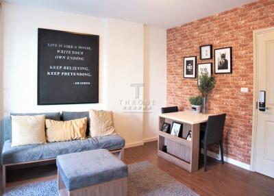 Cozy and stylish living room with brick accent wall and modern furnishings