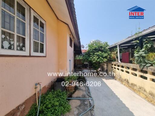 Residential home exterior with shaded patio and garden