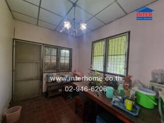 Spacious kitchen with large windows and vintage lighting