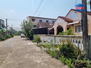 Residential street view with houses and clear sky