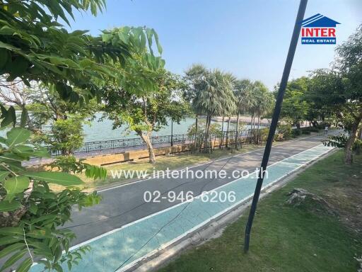 Scenic outdoor view of a waterfront walkway with lush greenery