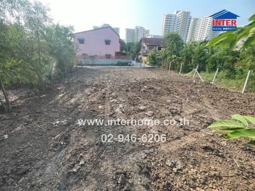 Empty land ready for development with buildings in the background