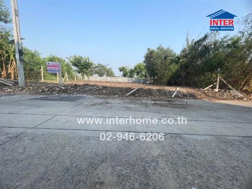 Vacant lot ready for development with clear skies and a contact sign