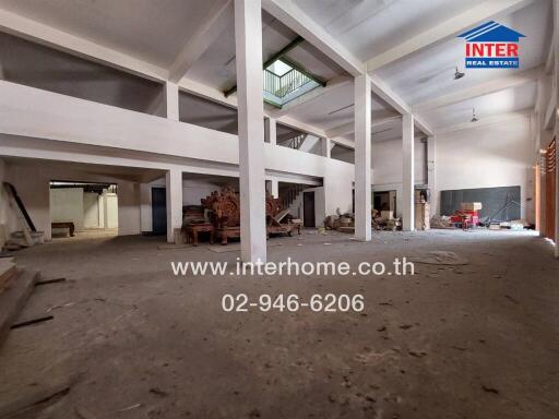 Spacious empty warehouse interior with large pillars