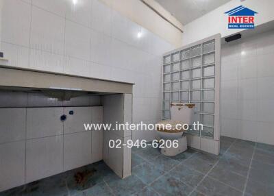 Spacious kitchen with tiled flooring and large sink