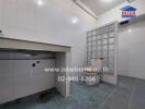 Spacious kitchen with tiled flooring and large sink