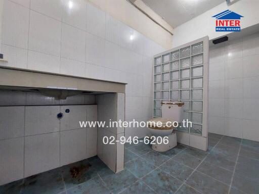 Spacious kitchen with tiled flooring and large sink