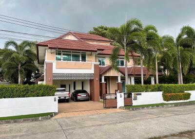 Spacious two-story residential home with a tiled roof and a landscaped front yard