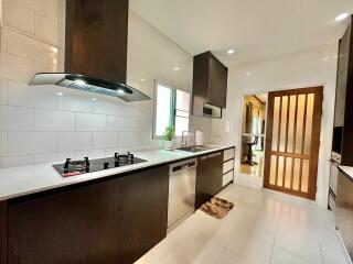 Modern kitchen with built-in appliances, ample storage, and sleek design.