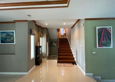 Spacious hallway with elegant staircase and modern furnishings