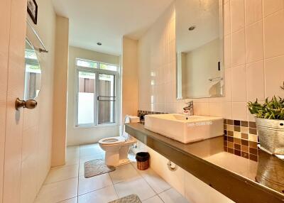 Modern bathroom with large mirror and natural light