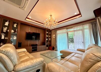 Spacious living room with luxury chandelier and comfortable seating
