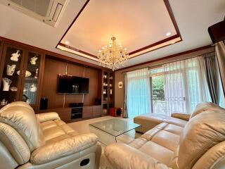 Spacious living room with luxury chandelier and comfortable seating