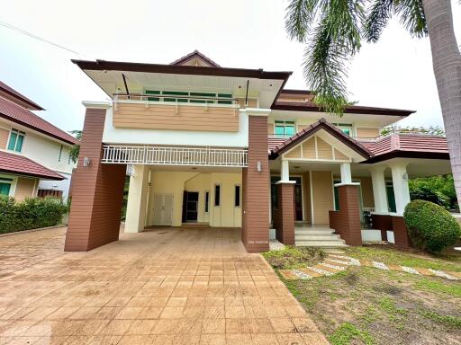 Modern two-story house with carport and garden