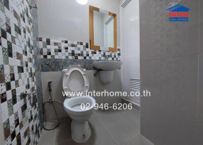 Modern bathroom with patterned tiles and sleek fixtures