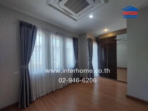 Spacious bedroom with ample natural light and modern air conditioning