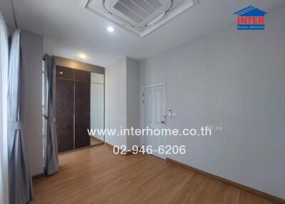 Spacious and bright bedroom with air conditioning and wooden flooring