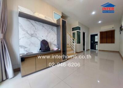 Spacious living room with large marble-like wall decor