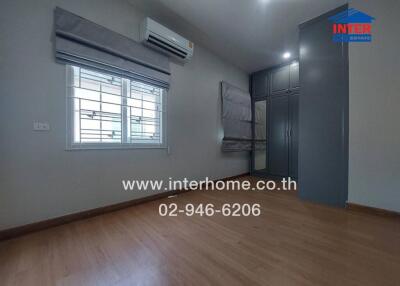 Spacious bedroom with air conditioning and large wardrobe