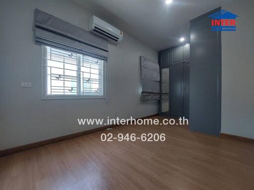 Spacious bedroom with air conditioning and large wardrobe