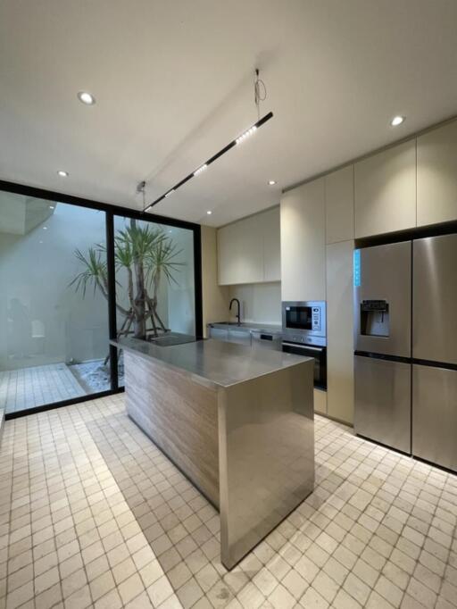 Modern kitchen with large central island and built-in appliances