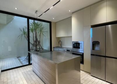 Modern kitchen with large central island and built-in appliances