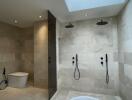 Modern bathroom with natural light, featuring a freestanding bathtub, walk-in shower, and elegant tiling