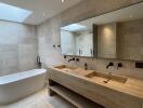 Modern spacious bathroom with large bathtub and dual sinks