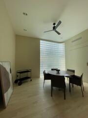 Spacious dining room with large glass block window and modern furniture