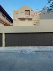 Modern residential building facade with a large garage door