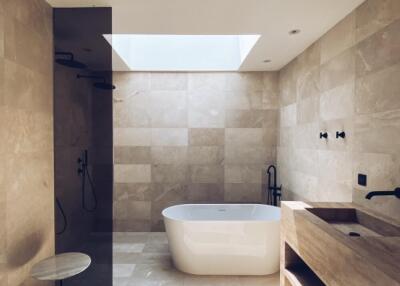 Elegant modern bathroom with natural light and freestanding bathtub
