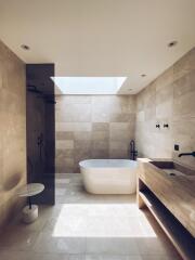 Elegant modern bathroom with natural light and freestanding bathtub