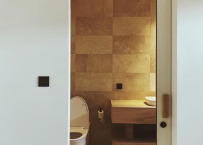 Modern bathroom interior with beige tiles and wooden accents
