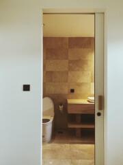 Modern bathroom interior with beige tiles and wooden accents