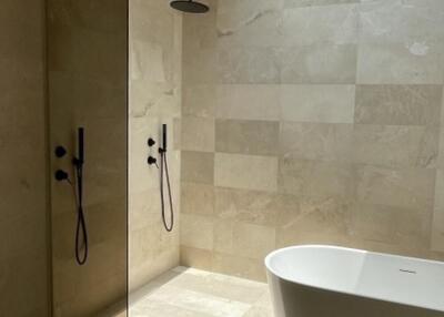 Modern bathroom with large walk-in shower and freestanding bathtub