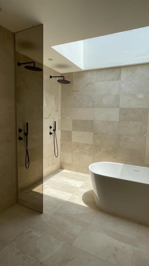 Modern bathroom with large walk-in shower and freestanding bathtub